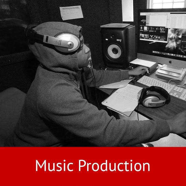 Student at the controls in a Clinton music production studio